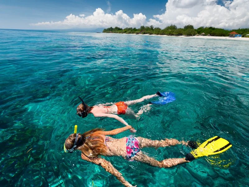 Two snorkelers explore the vibrant coral reefs of Nusa Lembongan. — Stay Well Package: Nusa Lembongan Adventure