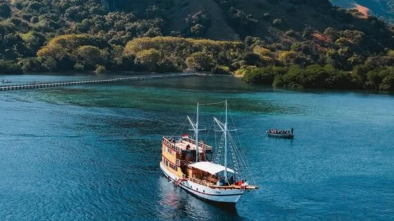 The Andalucia phinisi sailing through the clear waters of Komodo National Park. — Andalucia