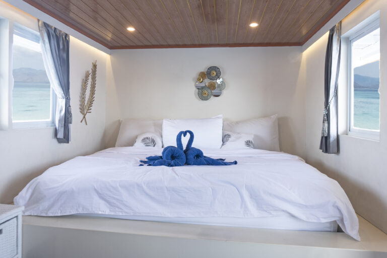 Luxurious private cabin with bed and sea views on Zendaya 02 Deluxe in Labuan Bajo